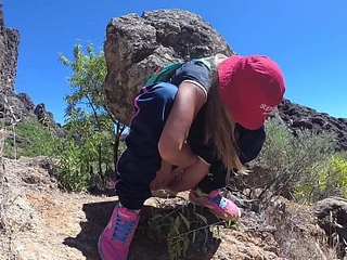 PISS PISS TRAVEL - Young girl tourist peeing relating to the mountains Gran Canaria. Public Canarias